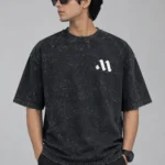 Front view of charcoal black acid wash drop shoulder t-shirt with minimal white chest logo