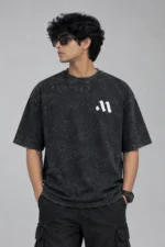 Front view of charcoal black acid wash drop shoulder t-shirt with minimal white chest logo